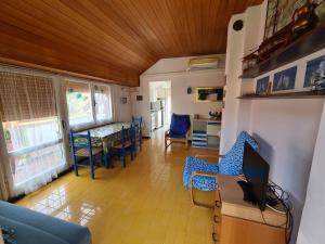 A television and/or entertainment centre at Verde Mare Aptm - Rooftop Terrace - near sea- A.C.