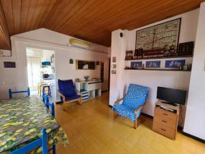 A television and/or entertainment centre at Verde Mare Aptm - Rooftop Terrace - near sea- A.C.