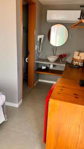a bathroom with a sink and a mirror at Pousada Alto Mar in Fernando de Noronha +28 photos