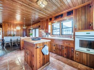 a large kitchen with wooden cabinets and a dining room at Sea Strapped in Surf City
