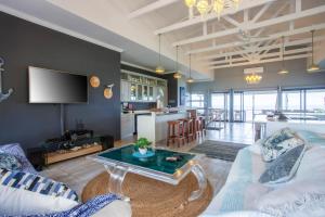 a living room with a couch and a table at Naudicals Dune in Chefe Imala