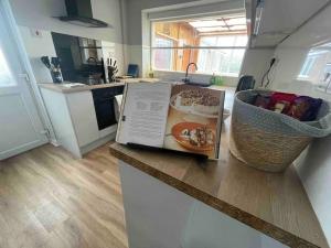 a kitchen with a table with a plate of food on it at LeeVal Detached House parking in Stockton-on-Tees