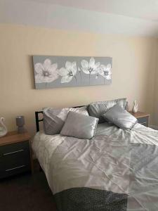 a bedroom with a bed with two pillows at LeeVal Detached House parking in Stockton-on-Tees