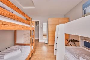 a room with two bunk beds and a hallway at Dunluce Park 6 - Portrush by the Sea in Portrush