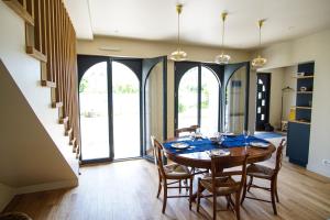 a dining room with a wooden table and chairs at -TY AR MOR- Belle maison corniche a 150m de la mer in Concarneau