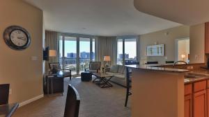 a large living room with a clock on the wall at Palms of Destin 2517 Luxury in the heart of Destin!!! in Destin