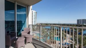 a balcony with chairs and a view of the ocean at Palms of Destin 2517 Luxury in the heart of Destin!!! in Destin