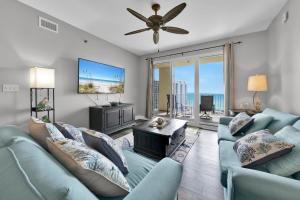 a living room with blue couches and a flat screen tv at Ariel Dunes I Unit 1209 Gulf view in Destin