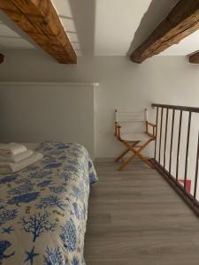 a bedroom with a bed and a chair at Mantellini 2B in Domodossola