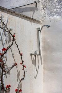 a shower on the side of a wall at Casa Vacanze Cattedrale in Ostuni +31 photos