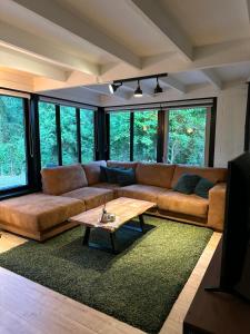 a living room with a couch and a coffee table at Vakantiehuis Lanaken in Lanaken