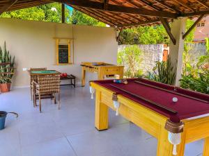 a pool table in the middle of a patio at Villa Velha Flats in Itamaracá