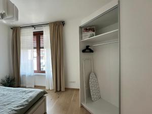 a bedroom with a bed and a glass closet at Zwirn1, uplne nové, parkovanie, klimatizacia, in Bratislava