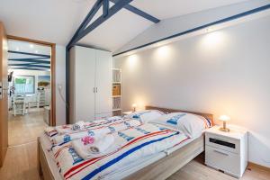 a bedroom with a large bed with people on it at Bungalow Uschi - Bgl 29 in Dranske