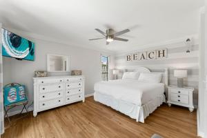 a white bedroom with a bed and a ceiling fan at Linkside 445 GFr4 Ks Kottage 2BR 2BA 7 in Destin