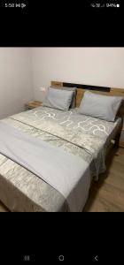 a large bed with two pillows on top of it at Konstantinos Apartment in Nea Moudania