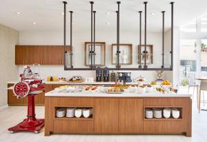 a kitchen with a counter with food on it at AC Hotel by Marriott Fort Lauderdale Beach in Fort Lauderdale