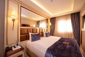 a hotel room with a bed and a mirror at Grand Marcello Hotel & SPA in Istanbul