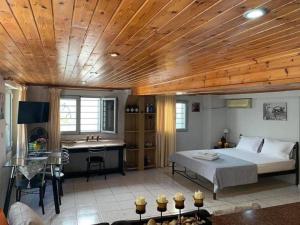 a bedroom with a bed with a wooden ceiling at Dolce Vita - In the heart of Lefkada - Lefkada BnB in Lefkada