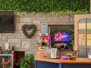 a restaurant with a sign that says open on a wall at Timbertop Suites - Adults Only in Weston-super-Mare