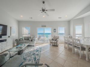 a living room with a table and a dining room at SEArenity in Surf City