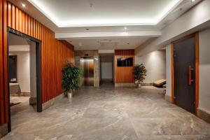 an office hallway with orange walls and a hallway with plants at Grand Marcello Hotel & SPA in Istanbul