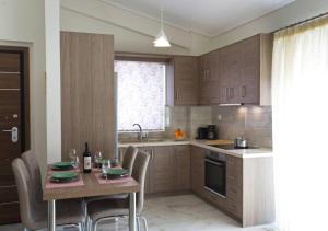 een keuken met een tafel, stoelen en een spoelbak bij Sunny Apartment Lefkada - Lefkada BnB in Lefkada