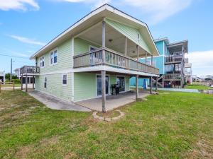a large green house with a large yard at Seahorse Sound in Topsail Beach