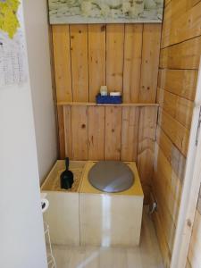 a bathroom with a toilet in a wooden room at CHAMBRE LA NOE in Saint-Cast-le-Guildo