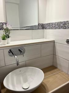 a bathroom with a white sink and a mirror at Il Melograno in Itri +4 photos