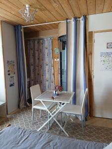 a table and chairs in a room with a bed at CHAMBRE LA NOE in Saint-Cast-le-Guildo +17 photos