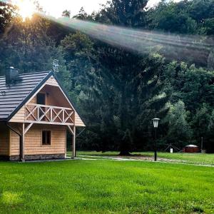 a house in a field with a sprinkler at Siedlisko nad Białką in Głuchołazy