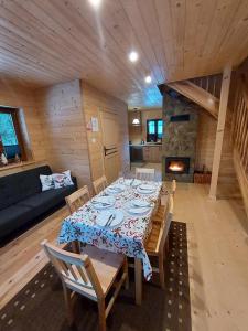 a dining room with a table and a fireplace at Siedlisko nad Białką in Głuchołazy