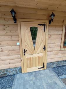 a wooden door in the front of a building at Siedlisko nad Białką in Głuchołazy