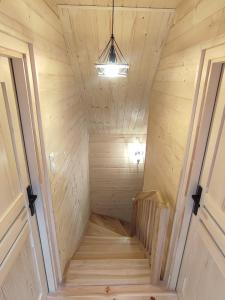 a staircase in a tiny house with a ceiling at Siedlisko nad Białką in Głuchołazy +6 photos