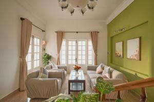 a living room with two couches and a table at Oliu Home Đà Lạt in Xuan An
