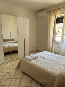a bedroom with a mirror and a bed at Mary T House in Campagnano di Roma