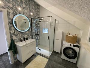 a bathroom with a sink and a washing machine at Penthouse Vanja in Bol +37 photos