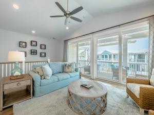 a living room with a couch and a table at Serenity By the Sea in Kure Beach