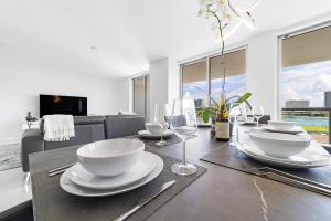 a dining room with a table with plates and wine glasses at Bay Harbor One Vacation in Miami Beach