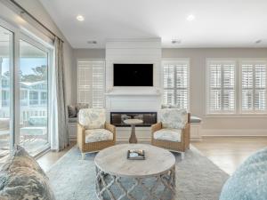 a living room with a fireplace and a tv at Serenity By the Sea in Kure Beach