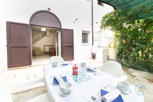 a white table and chairs on a patio at Villetta a schiera nella Pineta di Silvi Marina in Silvi Marina