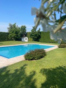 a swimming pool in the middle of a yard at VILLA SAVALIN in Taglio di Po