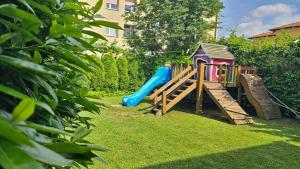 a playground with a slide in a yard at Brne Rooms in Postojna