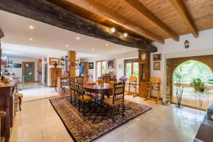 a kitchen and dining room with a table and chairs at Chez Papitou - Escapade Familiale en Bretagne in Saint-Adrien