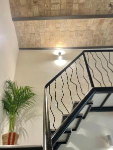a staircase with a light and a potted plant at FUTURA ROOM&RELAX in Termoli