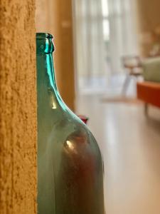 a green glass bottle sitting on the side of a wall at FUTURA ROOM&RELAX in Termoli