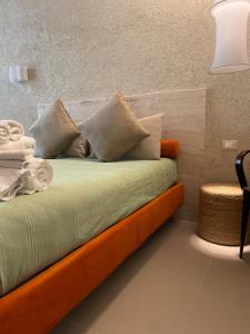 a bed with pillows on it in a room at FUTURA ROOM&RELAX in Termoli