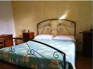 a bedroom with a bed with a wrought iron headboard at Al Mulino di Sant'Eufemia in La Strada