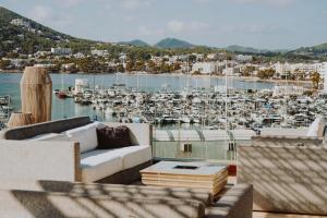 a living room with a view of a marina at Aguas de Ibiza Grand Luxe Hotel - Small Luxury Hotel of the World in Santa Eularia des Riu